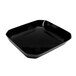 A black rectangular acrylic bowl with cut corners on a counter in a salad bar.
