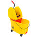 A yellow Rubbermaid mop bucket with a handle.