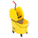 A yellow Rubbermaid mop bucket with a handle and wheels.