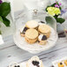 A Delfin clear acrylic dome cover with a stack of cookies inside.