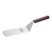 A Mercer Culinary Hell's Handle metal perforated turner with a wooden handle.