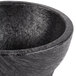 A black polypropylene Molcajete bowl with a handle.