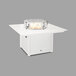 A POLYWOOD white fire pit table with a glass top with a fire in it.