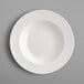A close-up of a RAK Porcelain ivory porcelain deep plate with a round edge.