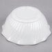 A white Cambro polycarbonate swirl bowl.