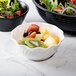 A bowl of fruit in a white bowl.