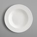 A close-up of a RAK Porcelain ivory porcelain deep plate with a round rim.