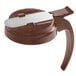 A brown plastic lid for a syrup server.