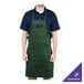 A man wearing a Chef Revival green poly-cotton apron with a pocket.