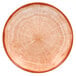 A close up of a RAK Porcelain Cedar Orange deep coupe plate with a tree trunk design.