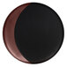 A close-up of a RAK Porcelain bronze and black deep plate with a moon shape.