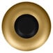 A gold porcelain plate with a black center and rim.