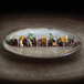 A RAK Porcelain Woodart Moss Green deep coupe plate with food on a table.
