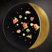 A black RAK Porcelain deep plate with food on it.