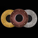 Three circular metal plates with black and gold metal fusion designs.