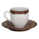 A brown and white porcelain espresso cup with a matching oak brown saucer.