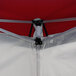 A white canopy tent with red accents.