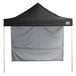 A black tent with a white cover.