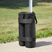 Two black Backyard Pro weight bags on a pole.