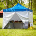 A Backyard Pro blue canopy tent set up on grass.