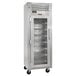 A Traulsen wine refrigerator with a glass door and shelves.