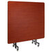 A wood rectangular National Public Seating cafeteria table with T-Mold edge on a stand.