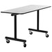 A National Public Seating mobile table with a black T-molding edge and wheels.
