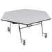 A white hexagonal table top with metal edges on a white table with black legs.