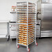 A rack of pastries on a Winholt aluminum sheet pan rack.