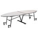 A white National Public Seating elliptical cafeteria table with wheels on it.