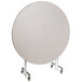 A round white table with a metal stand and wheels.