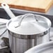 A Vollrath stainless steel domed cover on a pot.