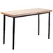 A National Public Seating adjustable utility table with black legs and a wooden butcher block top.