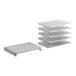 A stack of white plastic shelves with slats.