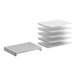 A stack of white plastic shelves with slats on top.