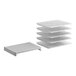 A stack of white plastic shelves with metal slats and holes.
