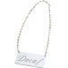 A silver chain sign that says "Decaf"