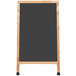 An oak A-frame sign board with a black chalkboard.