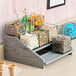 A Cal-Mil Ashwood Gray Oak display with jars filled with candy on a counter.