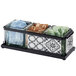 A black and white glass container with three compartments holding condiments on a counter.