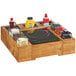 A Cal-Mil Madera rustic pine unit on a wooden counter with food items in it.