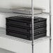 A black CaterGator food pan carrier with metal trays inside.