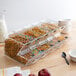 A group of Choice stackable dry food dispensers filled with cereals with a red apple on a table.