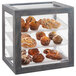 An Ashwood gray oak Cal-Mil bakery display case with pastries on trays inside.