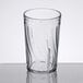 A clear Dinex plastic tumbler with a swirl pattern.