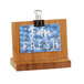 A wooden Cal-Mil menu holder with a paper clip on a table with a picture of fresh fruit.