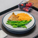 A Dinex induction base with a plate of food on a tray.