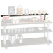 A Cal-Mil Cinderwood top shelf on a table with food items and a jar of lemonade with a lid.