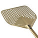A close-up of a GI Metal gold anodized aluminum square perforated pizza peel with a metal handle.