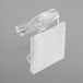 A clear plastic Snap Drape table skirt clip with a white plastic strip attached.